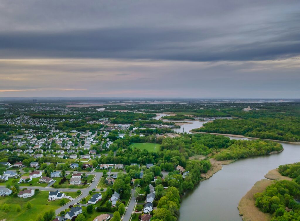 Aerial top view waterfront suburban street of middle class suburban neighborhood with houses